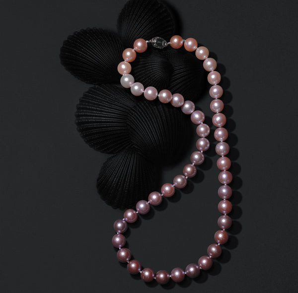 Timeless Pearl single-strand necklace with pink-to-lavender pearls.