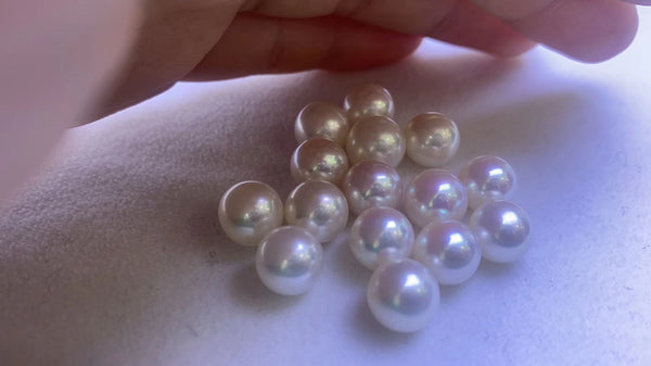 Several pearls from Timeless Pearl laid out on a white surface.