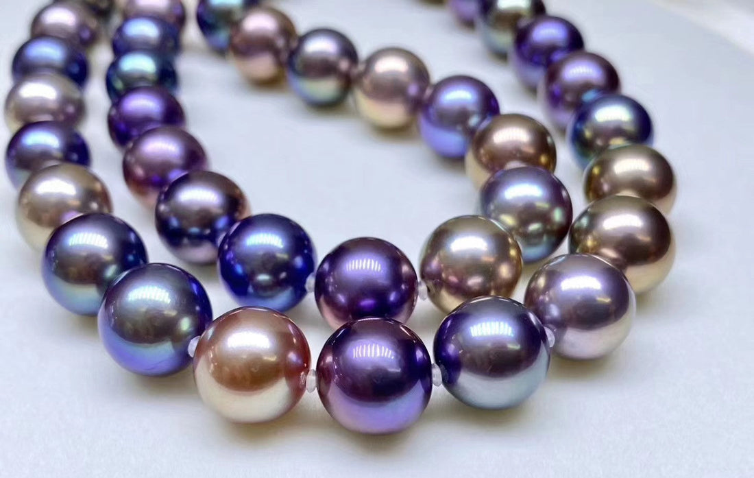 A Timeless Pearl necklace featuring large, round pearls with iridescent purple, blue, and bronze overtones.