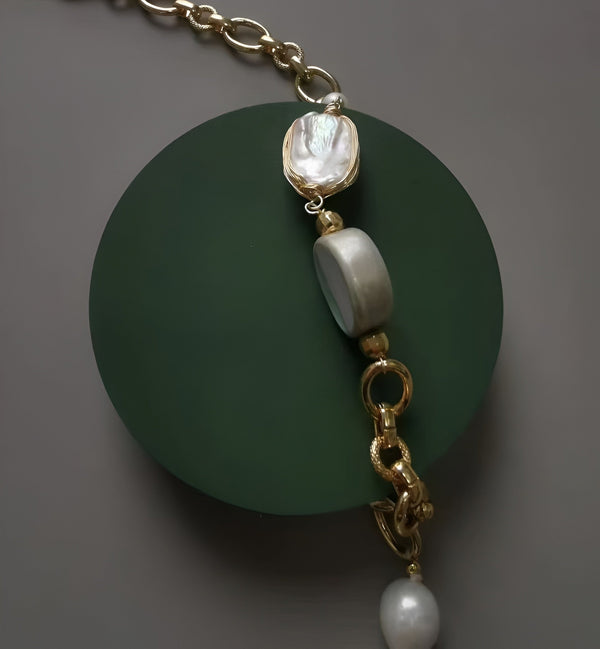 Statement necklace or bracelet segment featuring a large rectangular baroque pearl and an oval bead on a thick gold chain.