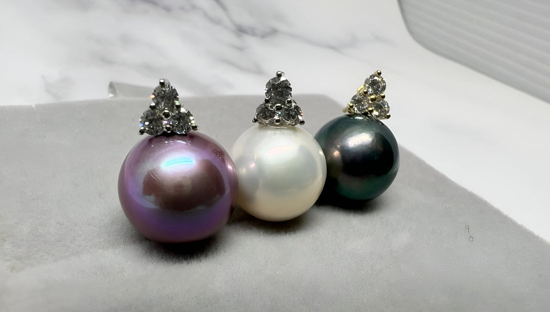 Three elegant pearl earrings in purple, white, and black tones from Timeless Pearl.