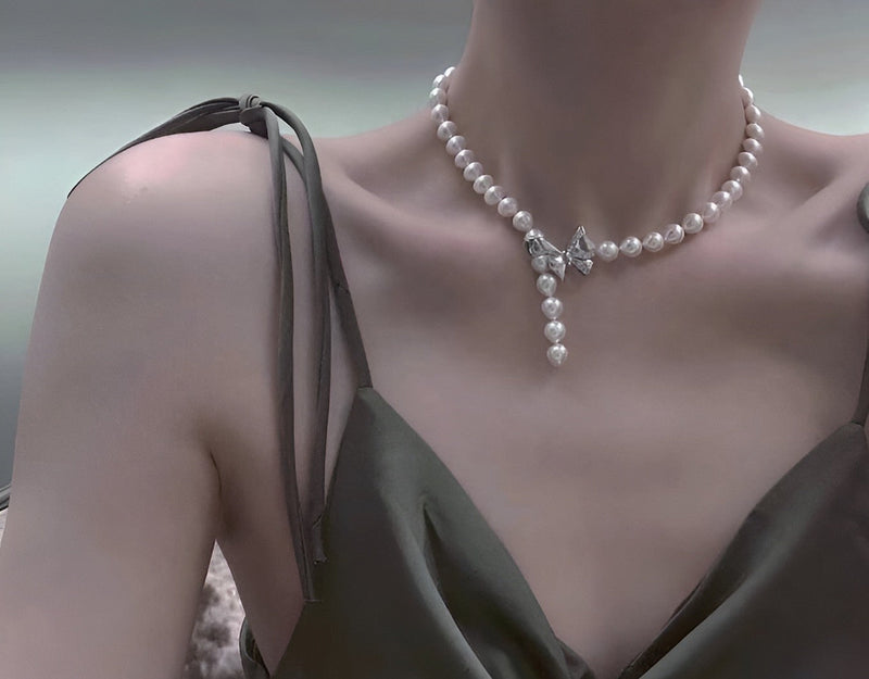 Timeless Pearl necklace with a bow detail styled against a soft satin dress.
