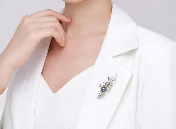 Timeless Pearl dark pearl brooch adding a refined accent to a white blazer.