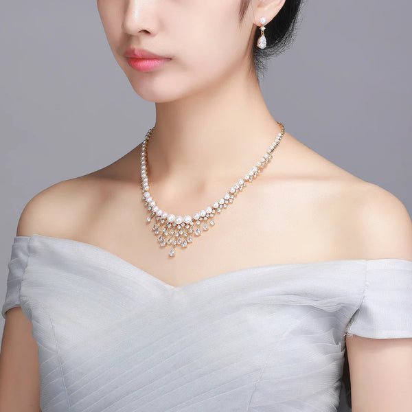 Timeless Pearl necklace and drop earrings styled with an off-shoulder white dress.