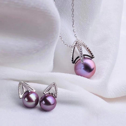 A pair of purple pearl earrings and a matching pendant necklace with silver accents and diamond-like embellishments, from Timeless Pearls.