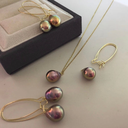Purple pearl jewelry set by Timeless Pearls featuring earrings, necklace, and ring with gold accents.