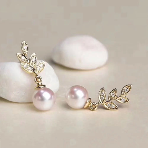 Delicate gold earrings featuring blue-gray pearl drops and marquise leaf accents by Timeless Pearls.