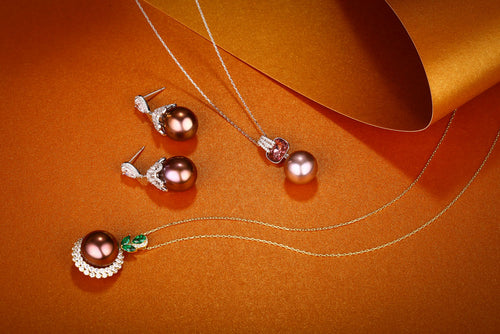 Luxury brown pearl earrings and pendant necklace with diamond accents and emerald details by Timeless Pearls.