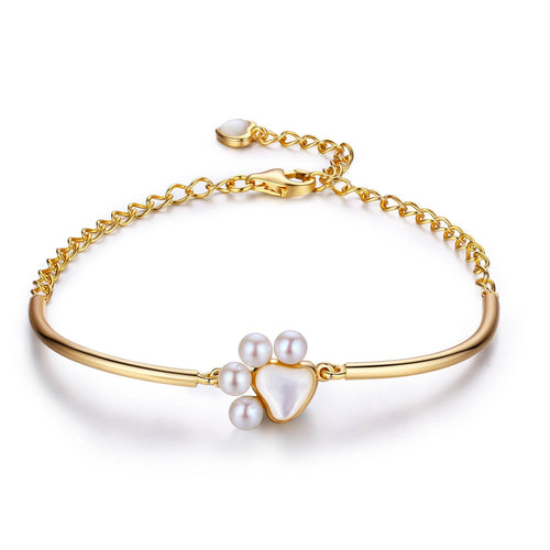 Gold bracelet with a paw print design featuring a large heart-shaped freshwater pearl and small round pearls