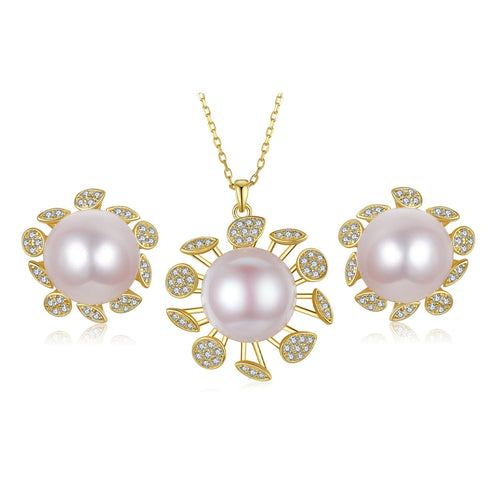 Gold necklace and earring set featuring large pink freshwater pearls surrounded by diamond-like accents in a flower design