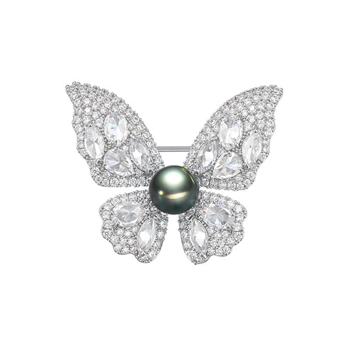 Silver butterfly brooch with a black pearl center and diamond-like marquise stones on the wings