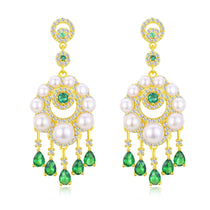 Classic pearl earring studs featuring lustrous white pearls on gold posts.