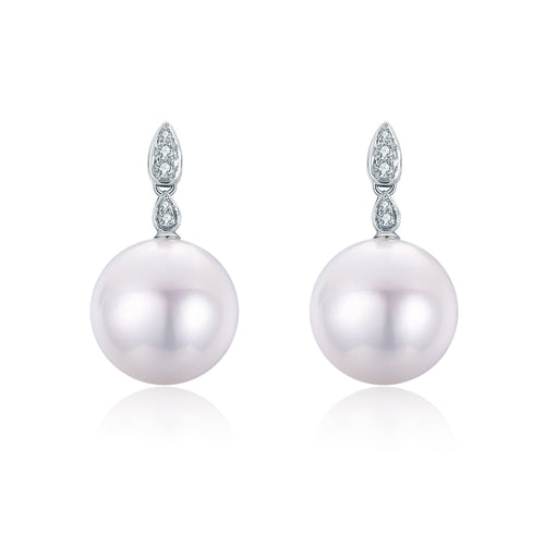 Elegant drop earrings featuring large pink freshwater pearls with diamond-like accents at the top