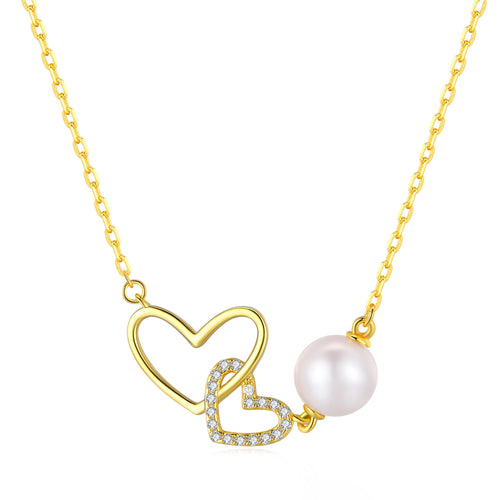 Gold necklace with two heart-shaped pendants, one plain and one encrusted with diamonds, and a large pink freshwater pearl