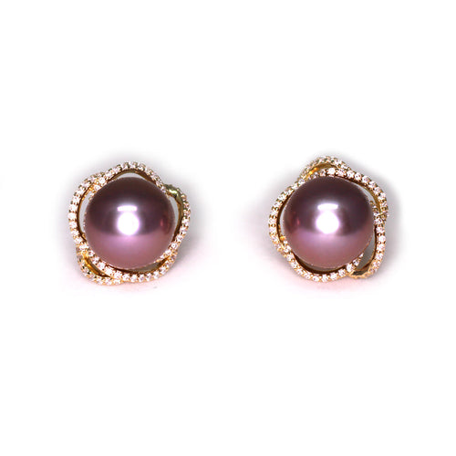 Gold earrings featuring large purple freshwater pearls surrounded by a swirl of diamond accents