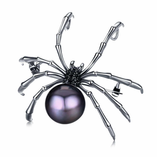 Spider-shaped brooch with a black freshwater pearl body and black gemstone detailing on silver legs
