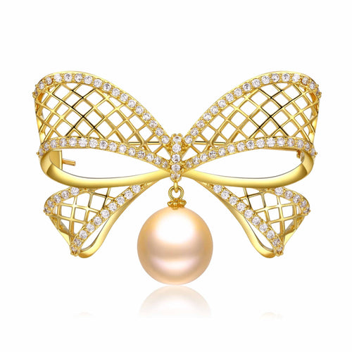 Gold bow-shaped brooch with diamond accents and a pink freshwater pearl drop