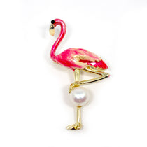 Flamingo-shaped brooch adorned with pearls and pink enamel details on gold-tone metal.